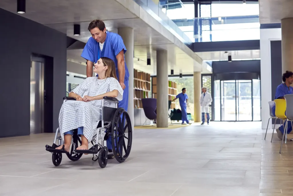 healthcare worker helping patient on wheel chair