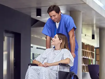 healthcare worker helping patient on wheel chair